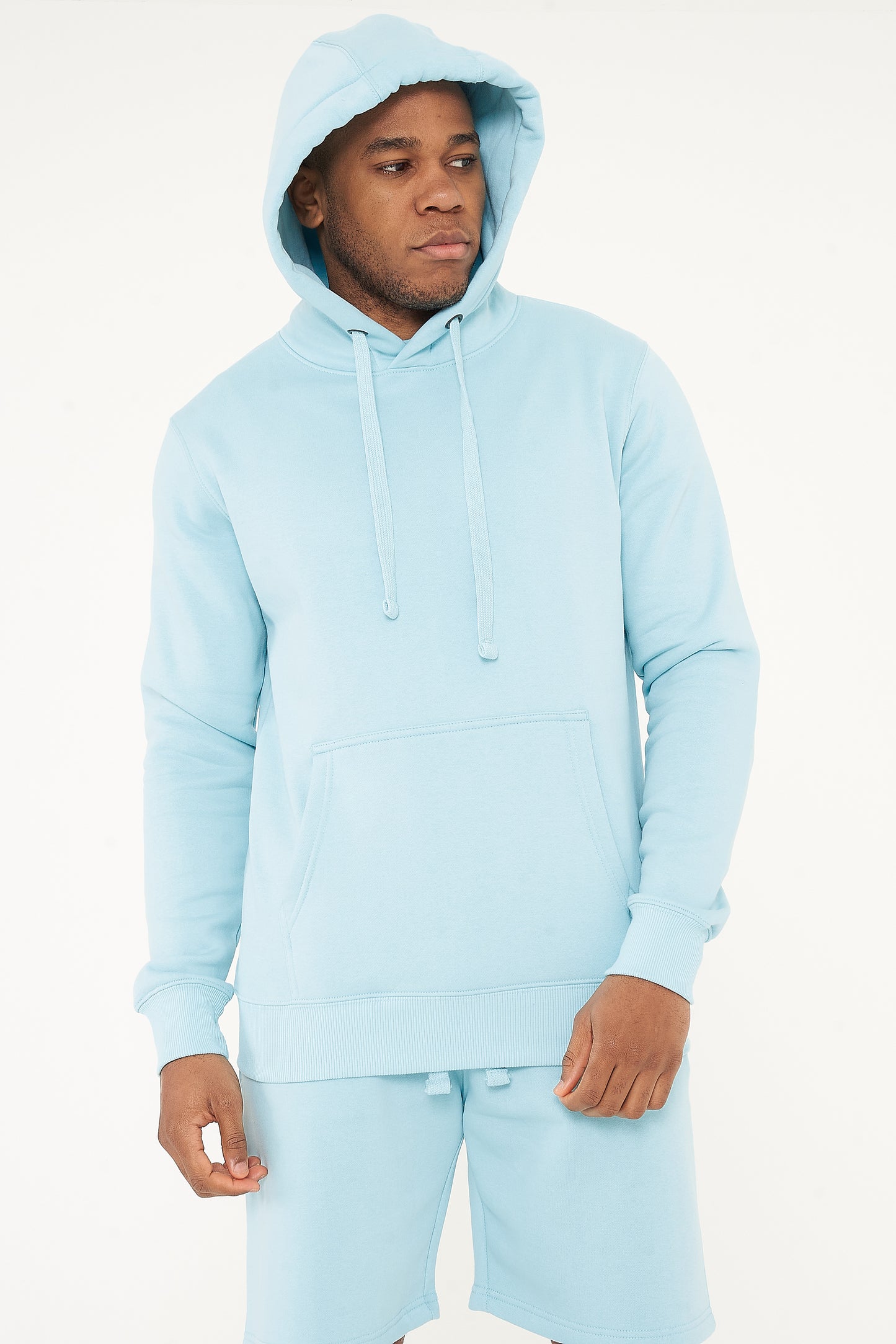 Model with hood on wearing 365 Regular Hoodie – men’s turquoise pullover hoodie for winter or layering.