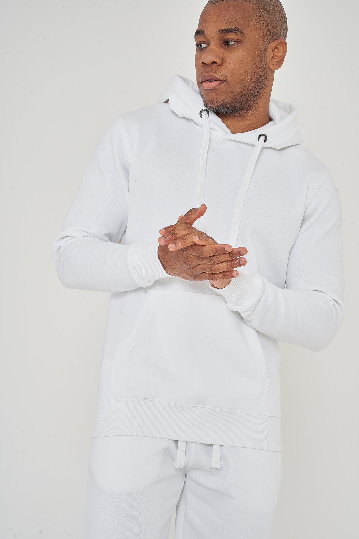 Model posing with arms clasped, wearing a men’s white regular-fit hoodie – 365 Collection.