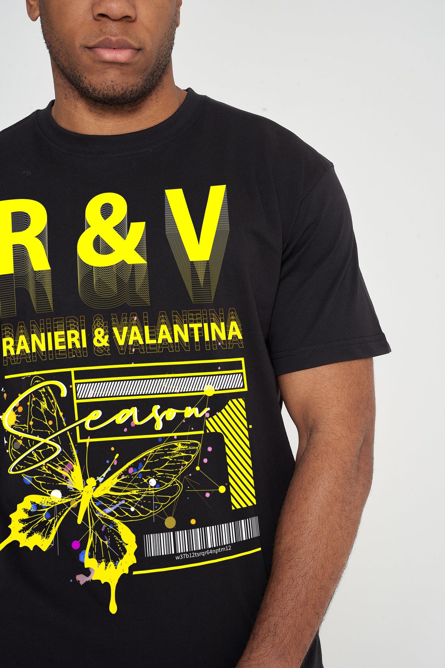 Male model front view wearing a black Yellow Butterfly Oversized T-shirt with vivid yellow butterfly graphic, styled with casual black shorts – oversized fit.