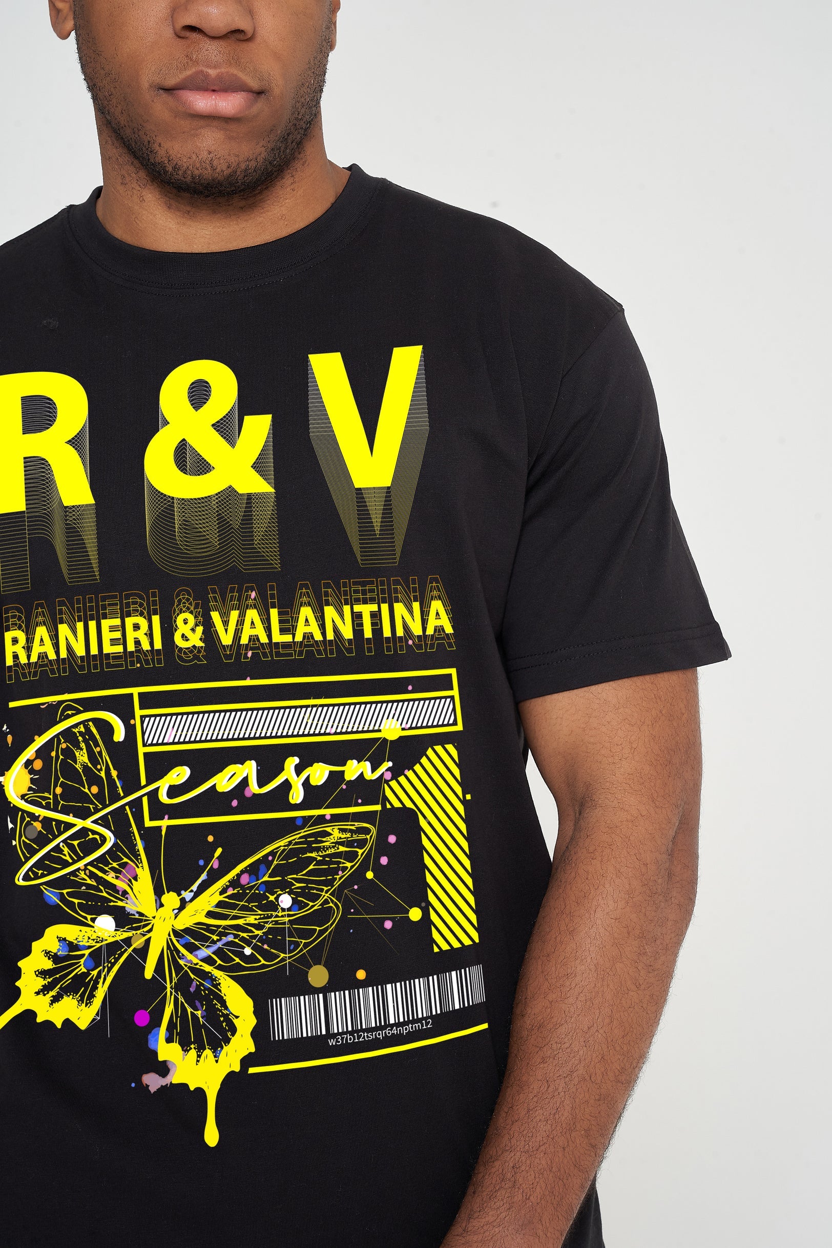 Male model front view wearing a black Yellow Butterfly Oversized T-shirt with vivid yellow butterfly graphic, styled with casual black shorts – oversized fit.