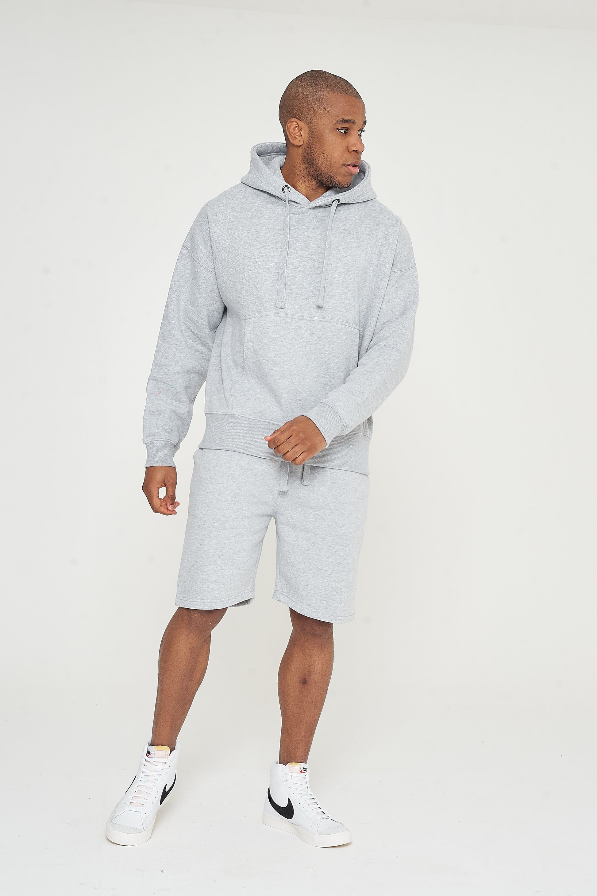 Side view of model walking in grey oversized hoodie - 365 Collection.
