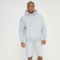 Model in full-body front view wearing grey oversized hoodie - 365 Collection.