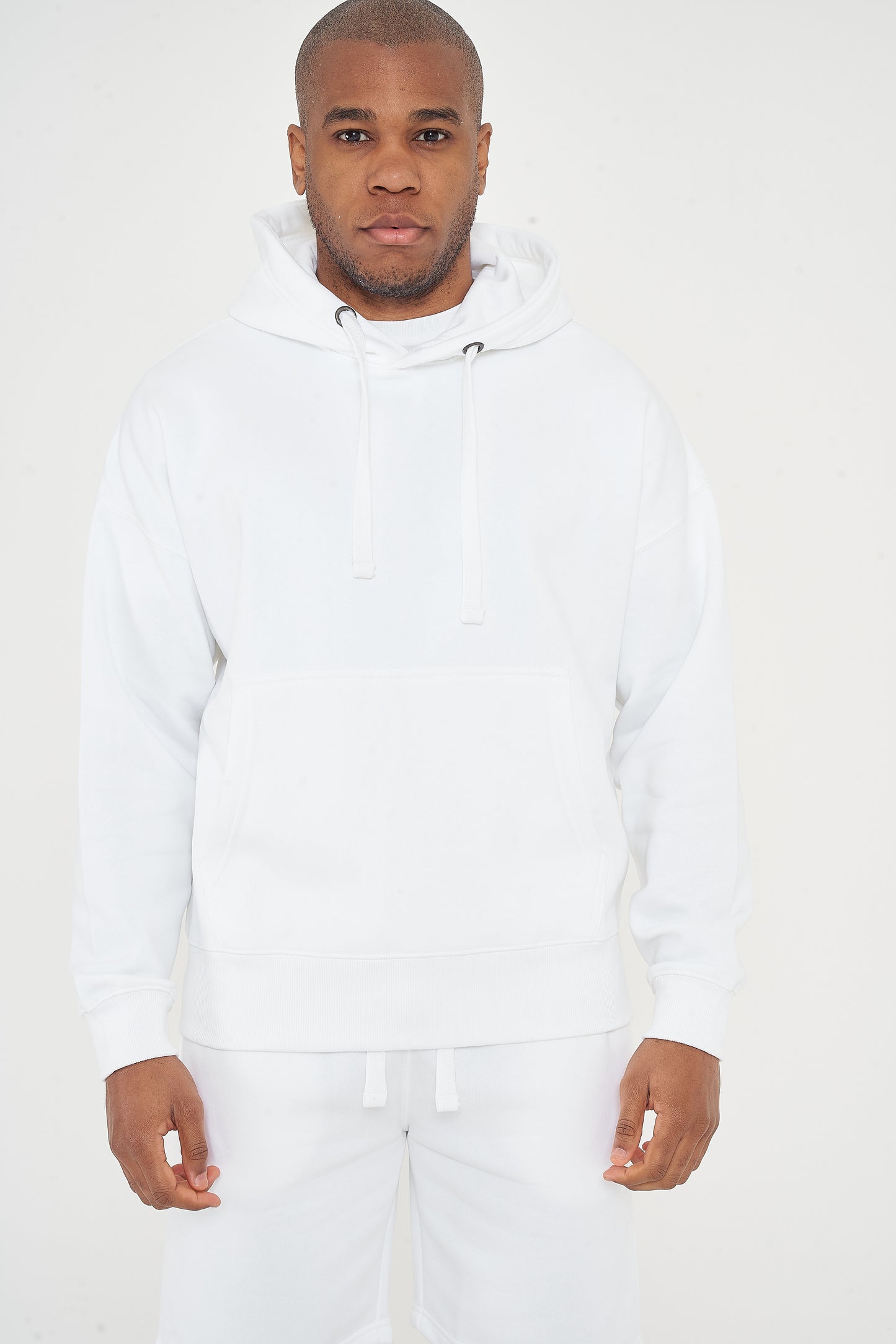 Upper body view of model in men's white oversized hoodie, head to waist, 365 Collection.