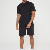 Male model front view wearing a black 365 Oversized T-shirt and black shorts – oversized fit, 365 Collection.