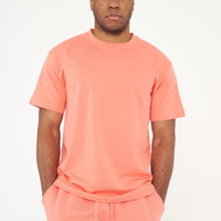 Male model standing in coral 365 Oversized T-shirt and shorts, relaxed posture – 365 Collection – oversized fit.