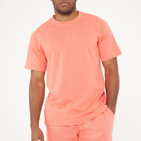 Male model front view wearing coral 365 Oversized T-shirt and matching shorts, hands relaxed – 365 Collection – oversized fit.