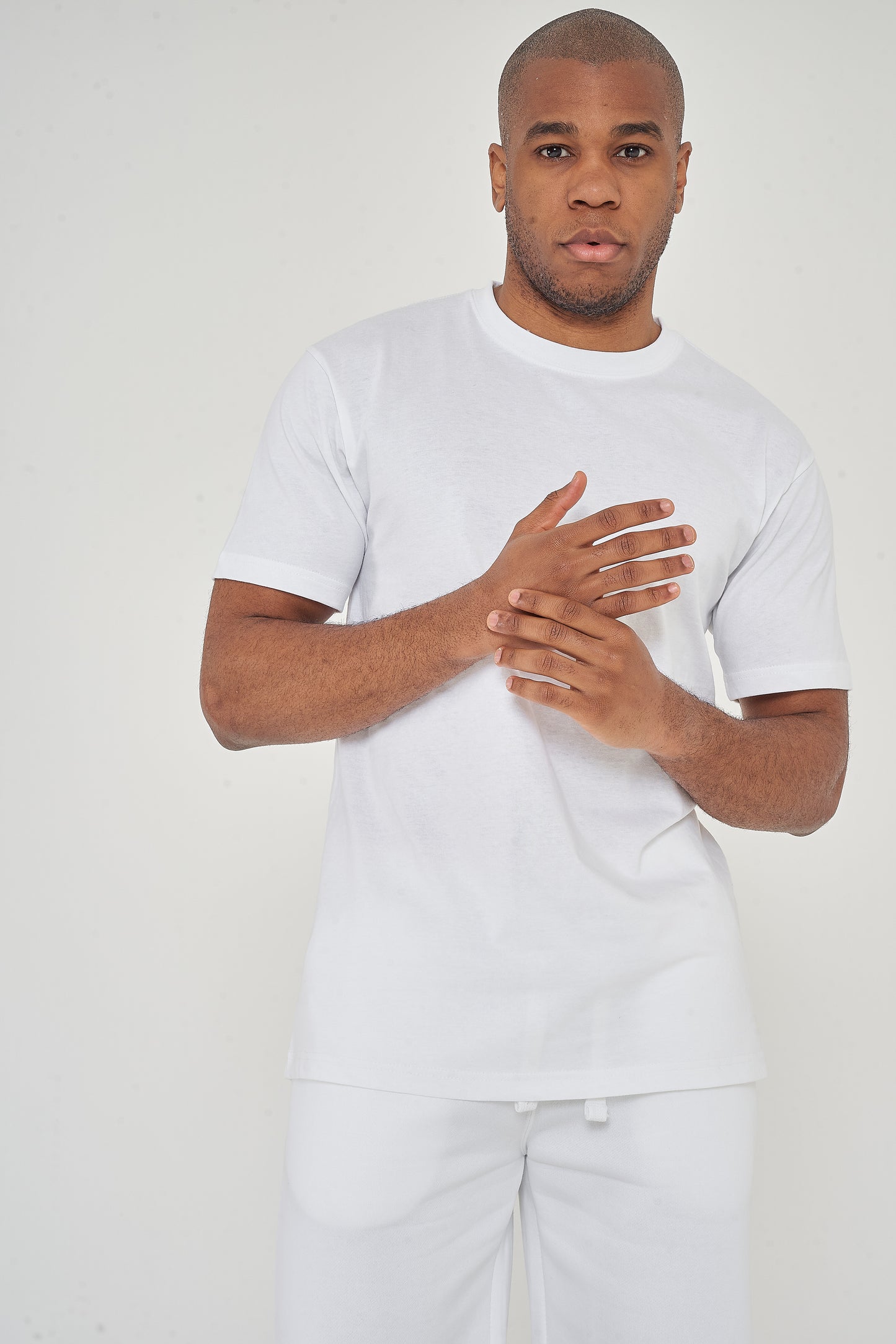 Front view worn by model - view with hands clasped each other.