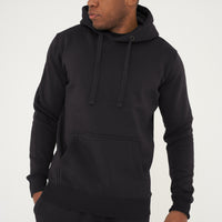 Male model standing in black 365 Regular Hoodie and shorts, hands relaxed – regular fit, 365 Collection.