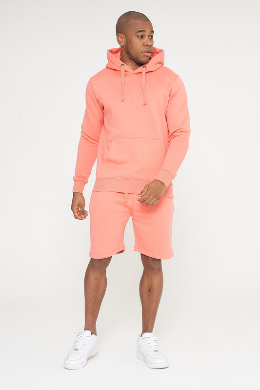 Male model front view wearing coral 365 Regular Hoodie and matching shorts – regular fit, 365 Collection.