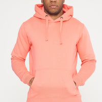 Male model standing, hands relaxed, in coral 365 Regular Hoodie and shorts – regular fit, 365 Collection.