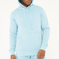 Model with hood on wearing 365 Regular Hoodie – men’s turquoise pullover hoodie for winter or layering.