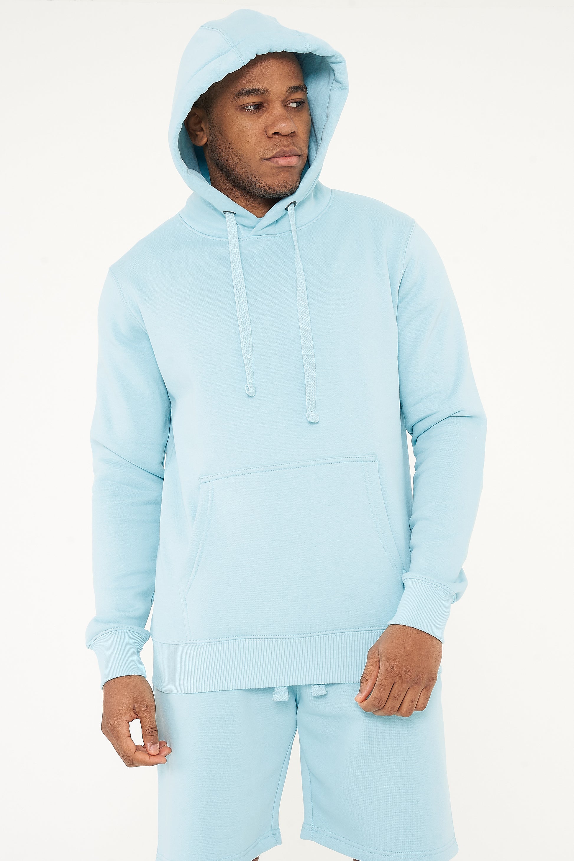 Model with hood on wearing 365 Regular Hoodie – men’s turquoise pullover hoodie for winter or layering.