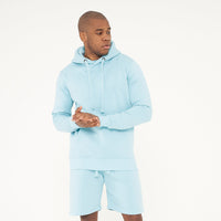 Model wearing 365 Regular Hoodie in turquoise with matching shorts – men’s casual streetwear outfit.