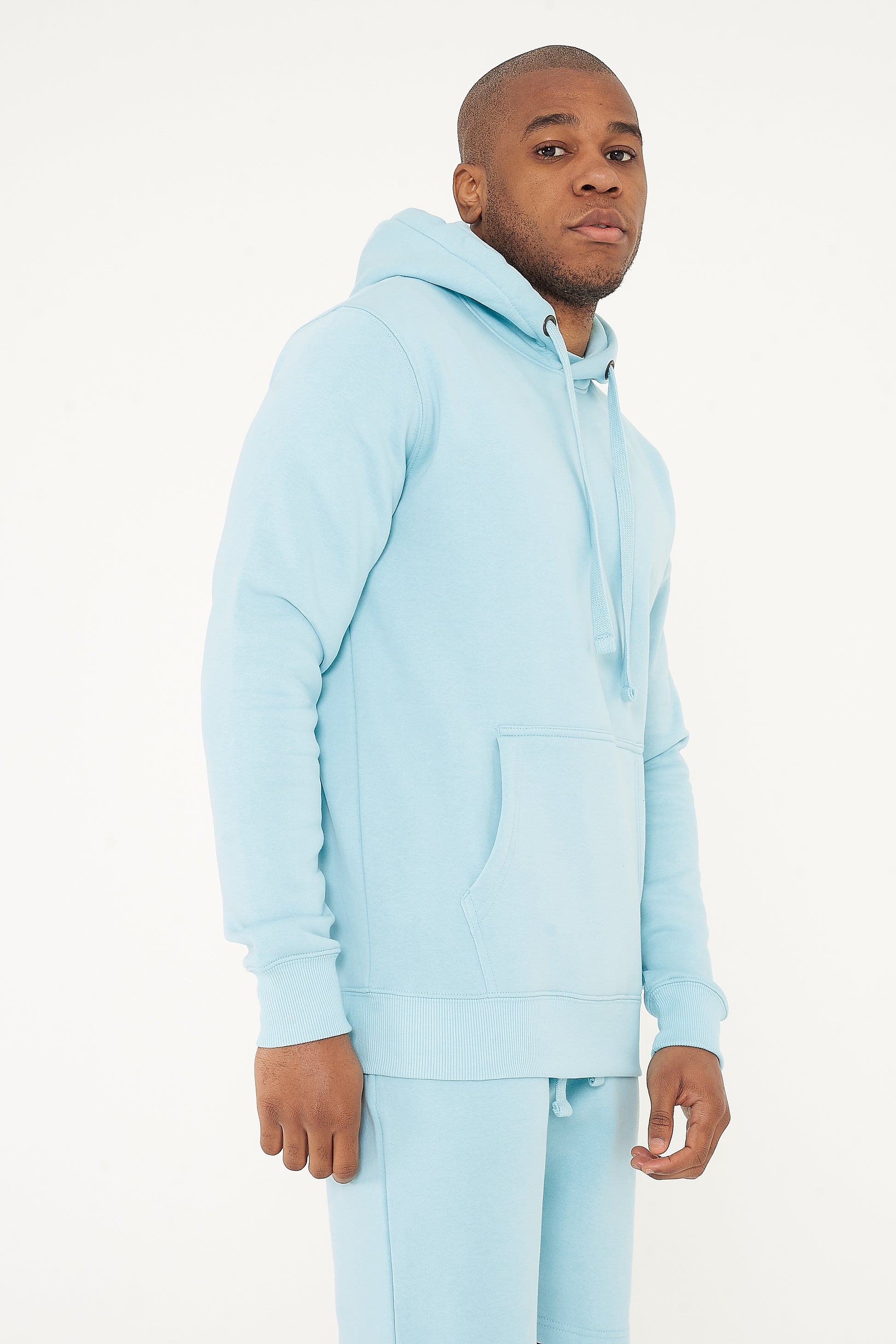 Side view of model in turquoise 365 Regular Hoodie – stylish men’s hoodie for daily wear.