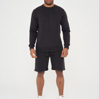 Male model front view wearing black 365 Regular Sweatshirt and matching shorts – regular fit, 365 Collection.