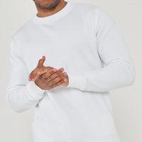 Upper-body front view of male model wearing white oversized sweatshirt with hands clasped – 365 Collection.