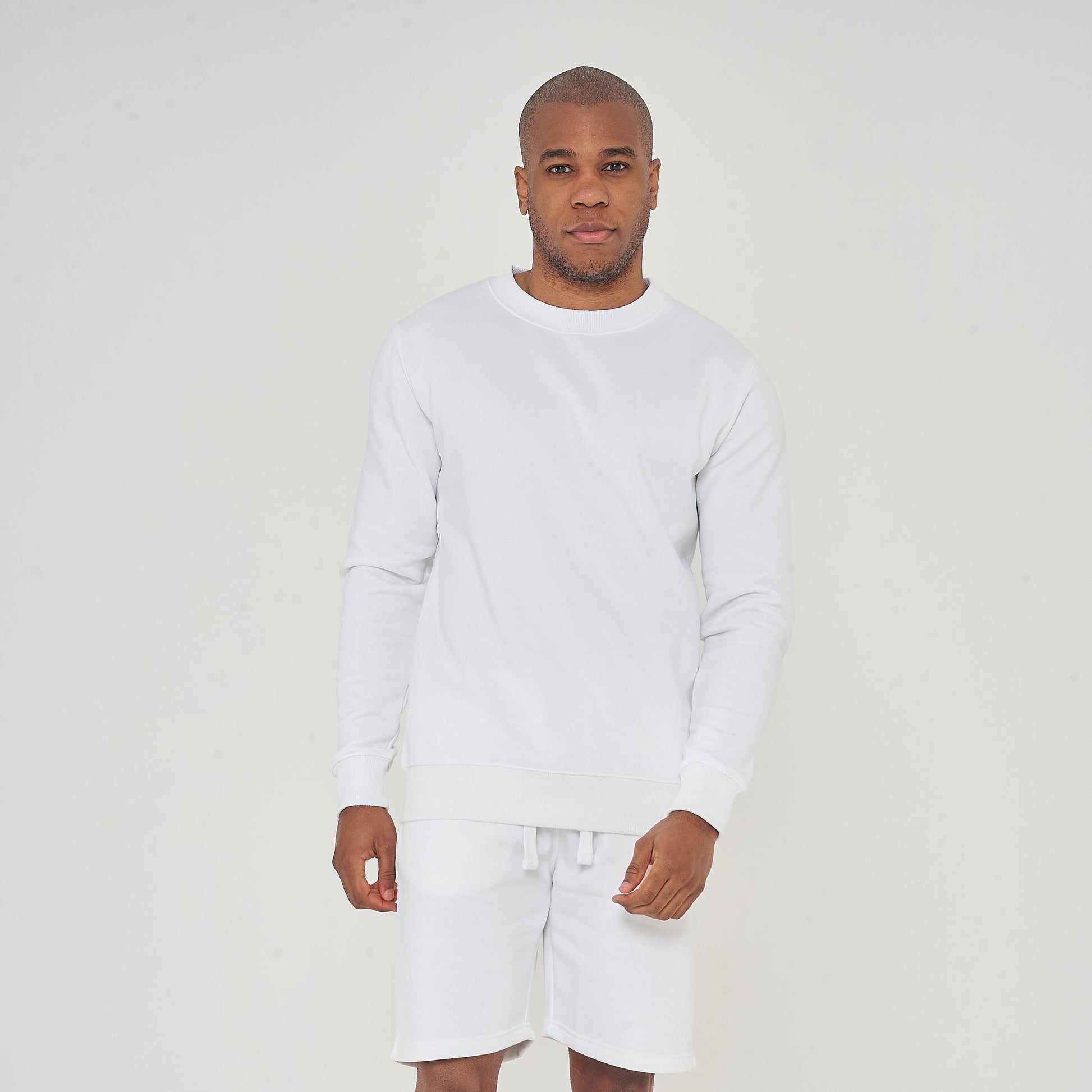 Full-body front view of male model wearing white oversized sweatshirt – 365 Collection.