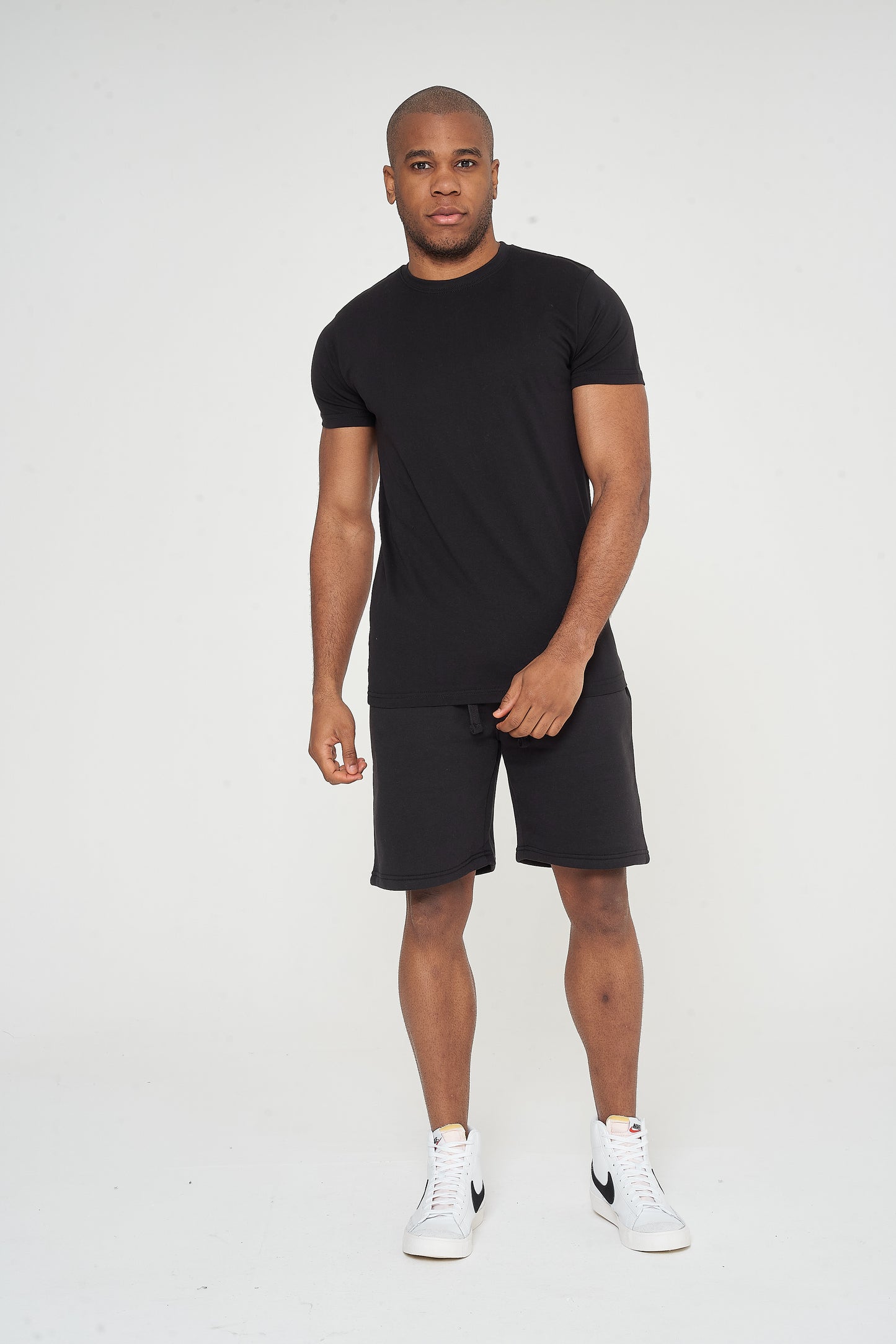 Male model front view wearing black 365 Regular T-shirt and matching shorts – regular fit, 365 Collection.