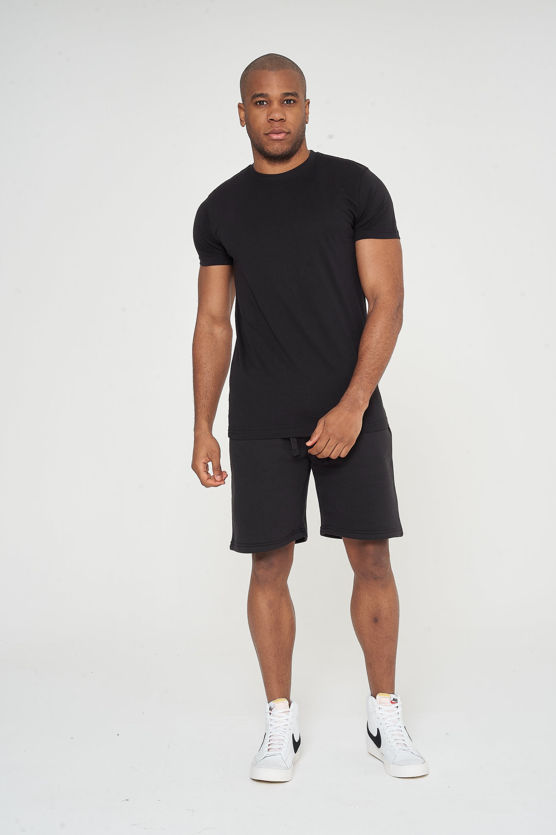 Male model front view wearing black 365 Regular T-shirt and matching shorts – regular fit, 365 Collection.