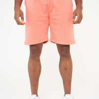 Male model front view wearing coral 365 fleece shorts and matching T-shirt – relaxed fit, 365 Collection. 