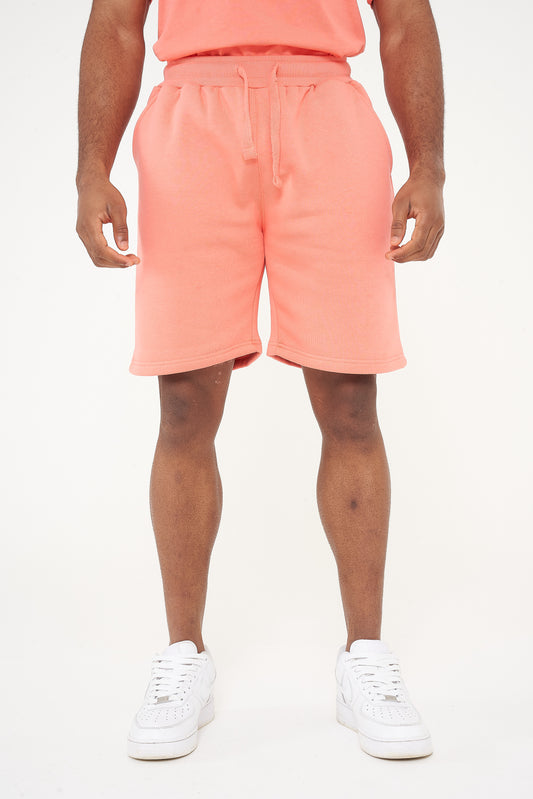 Male model front view wearing coral 365 fleece shorts and matching T-shirt – relaxed fit, 365 Collection. 