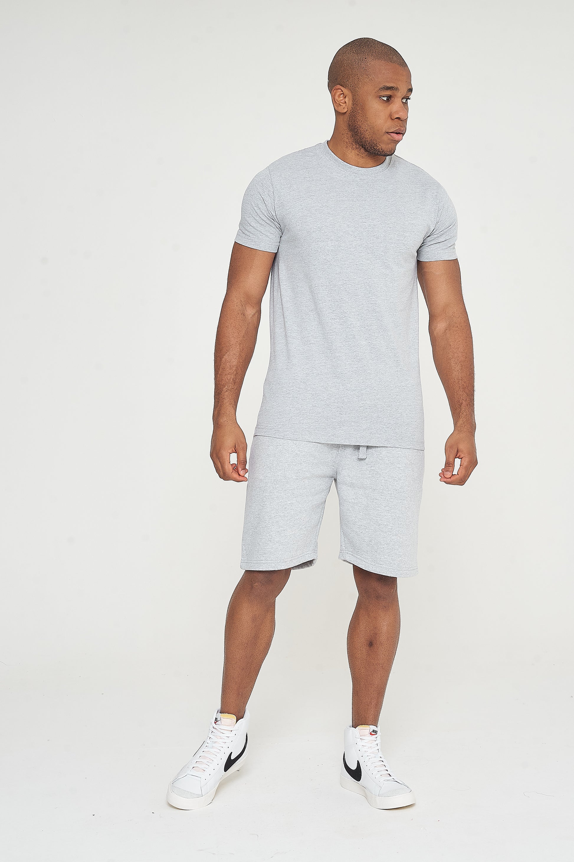 Side pose of model in 365 Shorts grey - lightweight cotton shorts for men’s daily wear.