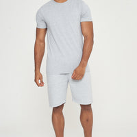 Model walking forward in grey regular-fit shorts and a matching T-shirt - 365 Collection.