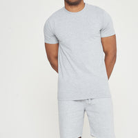 Model standing front view wearing grey regular-fit shorts with a matching T-shirt – 365 Collection.