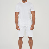 Front view of model wearing men's white regular-fit shorts, 365 Collection.