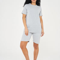 Woman wearing a basic grey t-shirt with matching shorts, front view. 