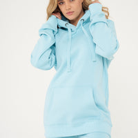 Side view of woman modeling turquoise hoodie, highlighting drawstrings and sleeve detail.
