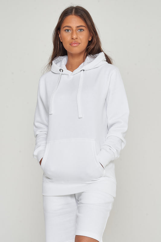 Side view of a woman in a basic white hoodie and shorts, showing relaxed streetwear style. 