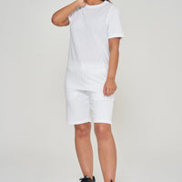 Woman wearing basic white t-shirt with casual shorts, front view.