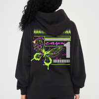 Woman wearing green Butterfly Season One graphic hoodie, relaxed fit and back print visible.