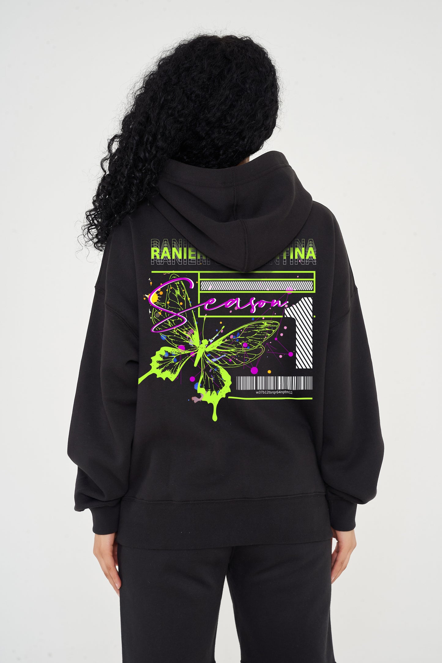 Woman wearing green Butterfly Season One graphic hoodie, relaxed fit and back print visible.