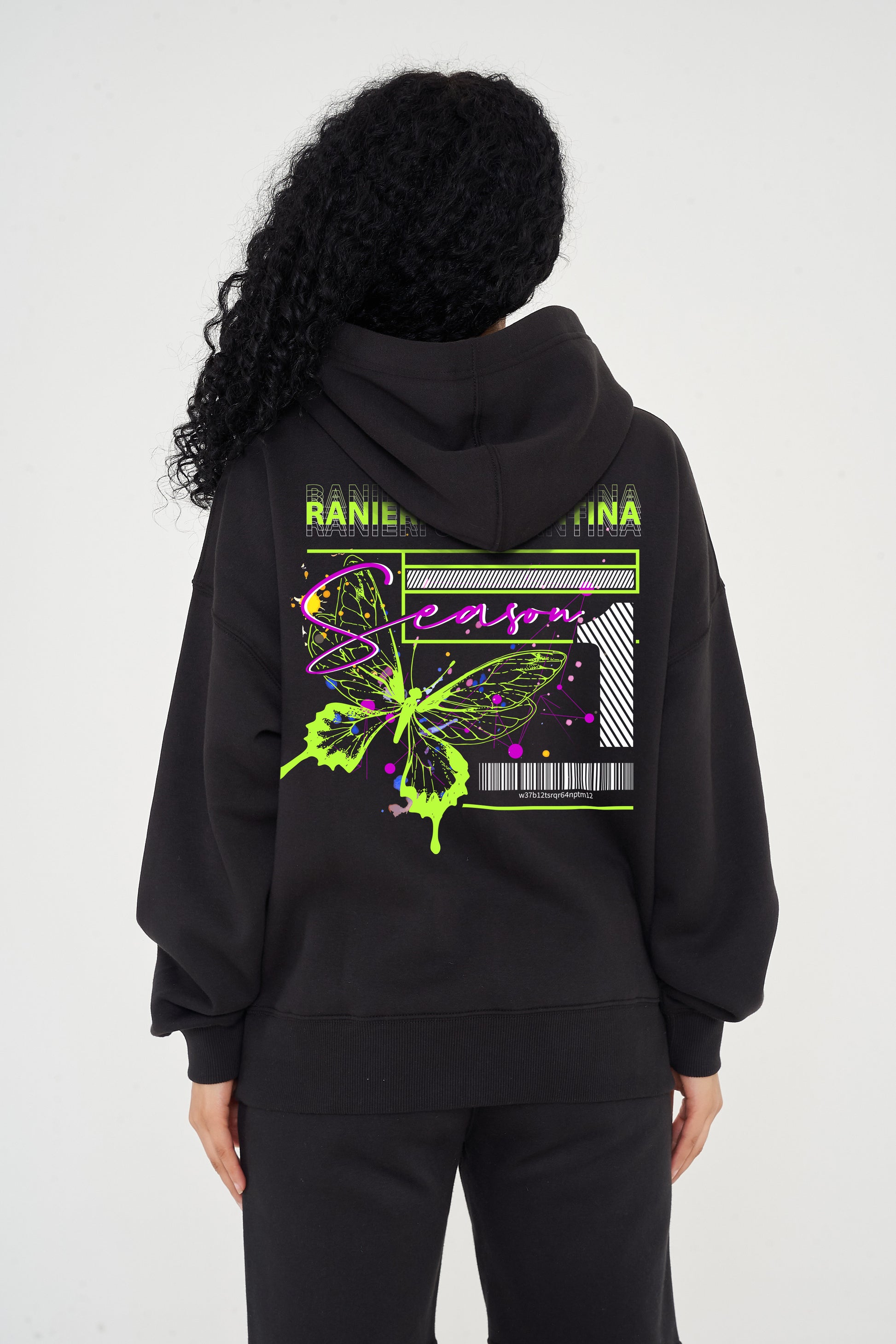 Woman wearing green Butterfly Season One graphic hoodie, relaxed fit and back print visible.