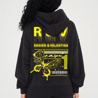 Woman wearing yellow Butterfly Season One graphic hoodie styled casually, showing back print and relaxed fit.