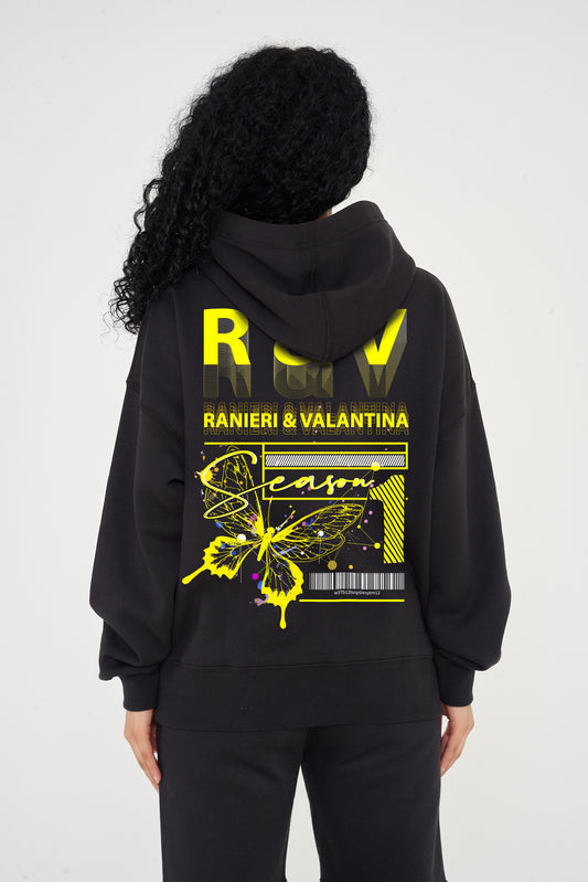 Woman wearing yellow Butterfly Season One graphic hoodie styled casually, showing back print and relaxed fit.