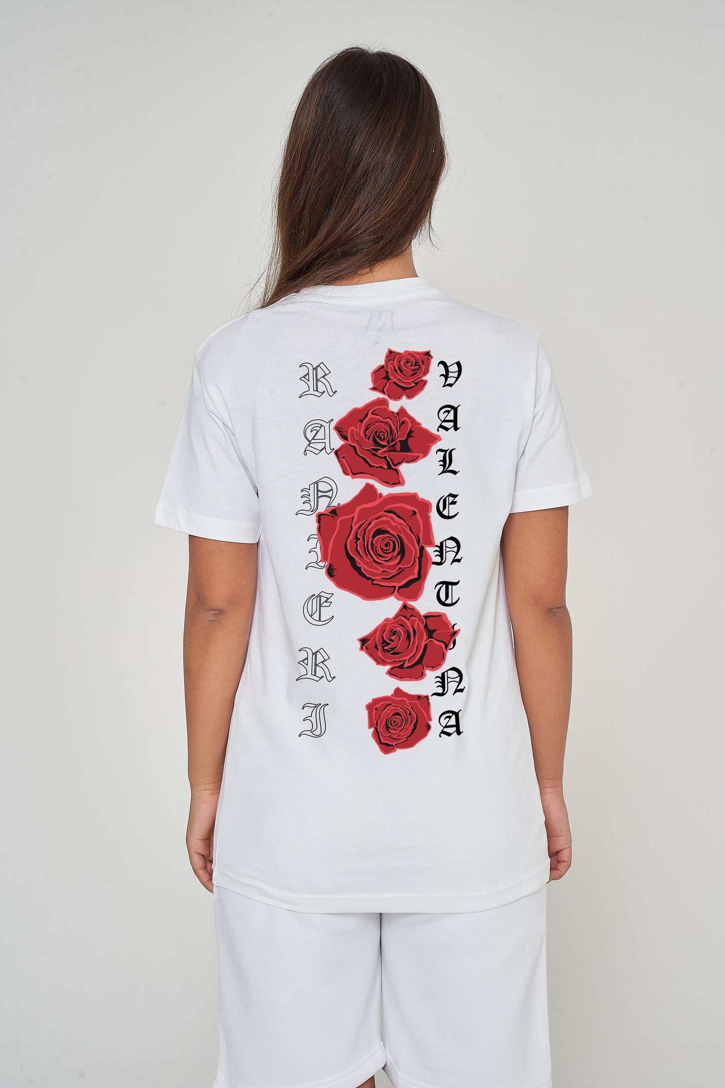 Woman wearing the white Gothic Roses Oversized T-Shirt styled with casual bottoms, highlighting the dramatic back floral print and comfortable relaxed fit.