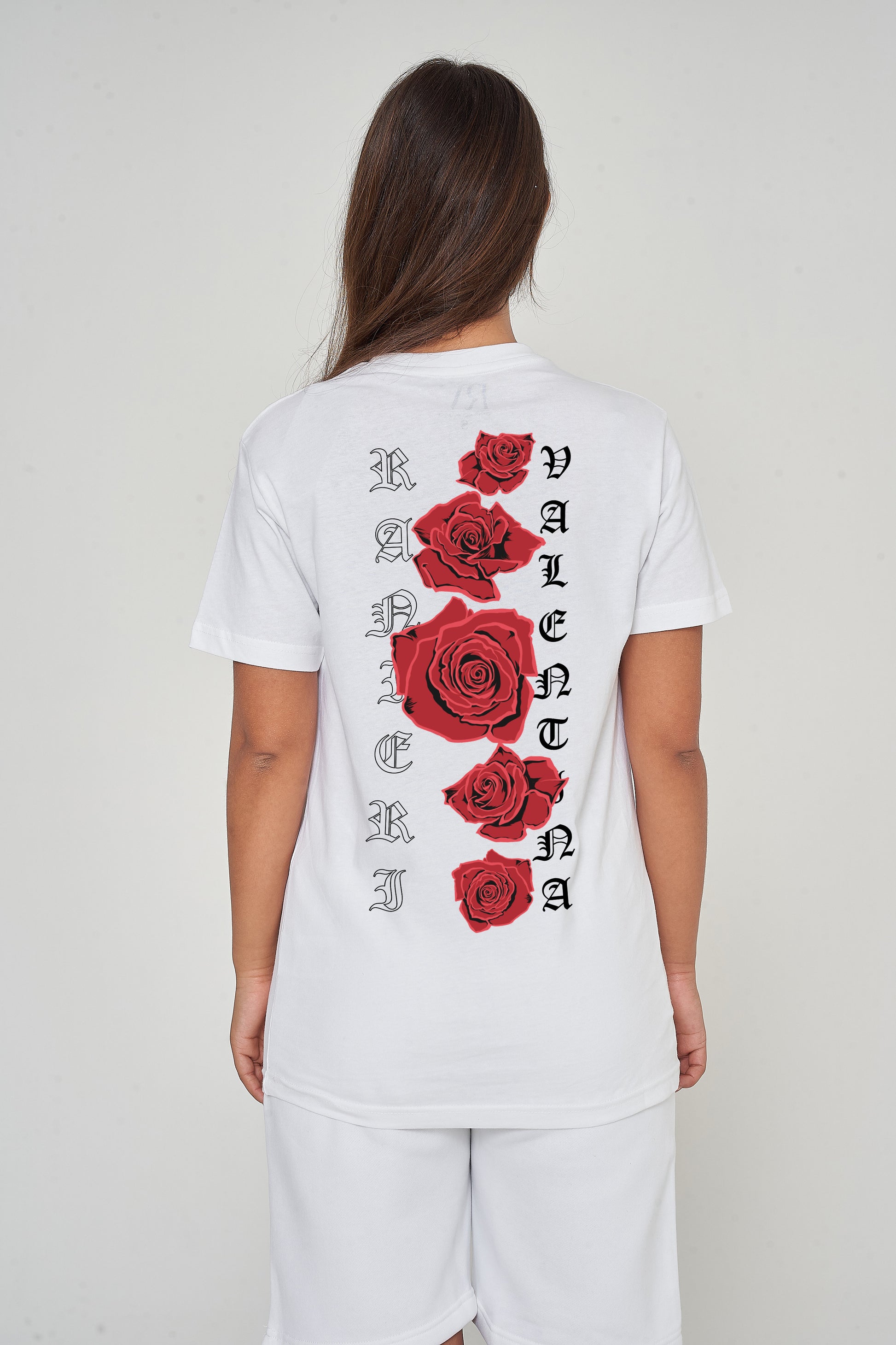 Woman wearing the white Gothic Roses Oversized T-Shirt styled with casual bottoms, highlighting the dramatic back floral print and comfortable relaxed fit.