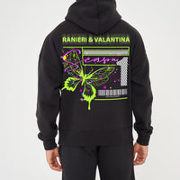 Rear view of male model wearing black oversized hoodie with vivid green butterfly graphic and Ranieri & Valantina logo – oversized fit.