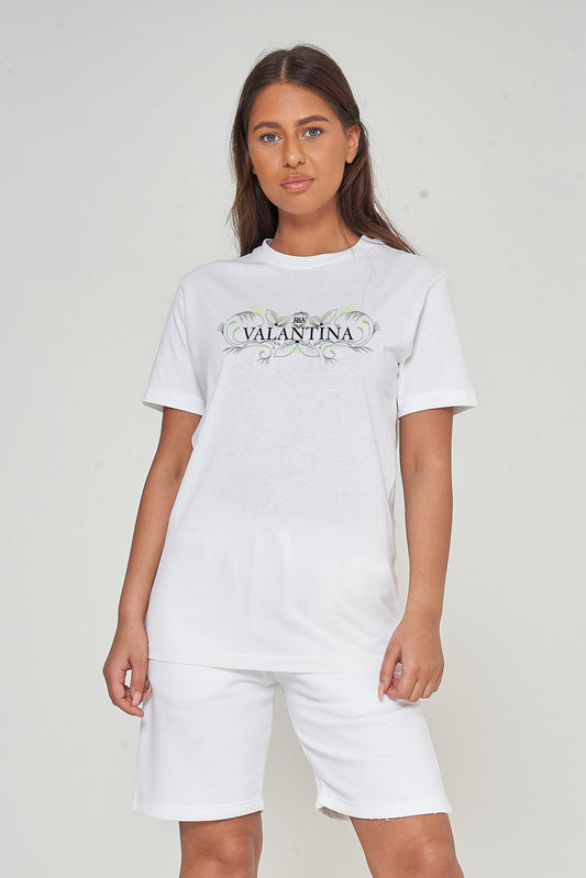 Woman wearing the white Green Peacock Oversized T-Shirt styled with casual bottoms, highlighting the front peacock print and comfortable fit.