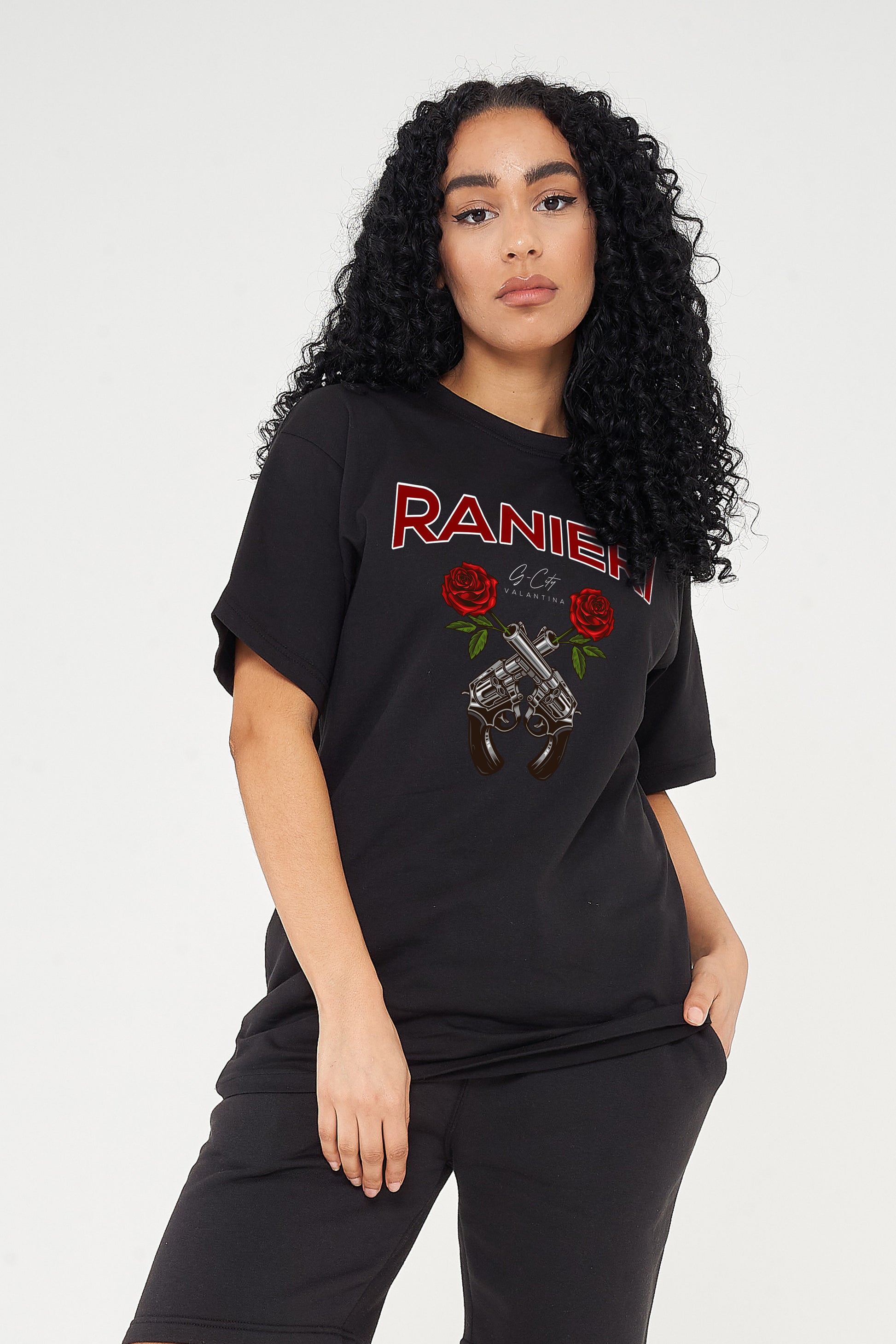 Woman wearing the Guns & Roses Oversized T-Shirt styled with black jeans, highlighting the bold front graphic and comfortable oversized fit.