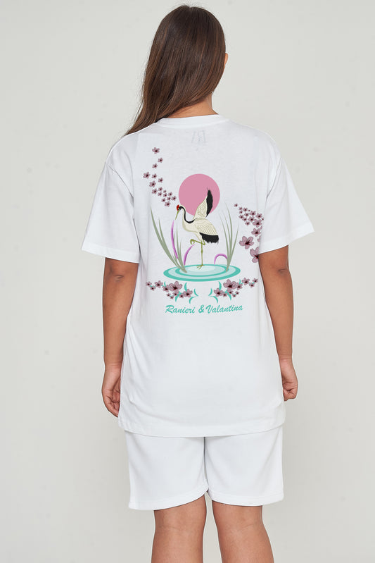 Woman wearing Japanese Waters oversized white T-shirt, back view revealing tranquil Japanese print.