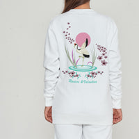 Woman wearing a white Japanese Waters sweatshirt, back view highlighting a unique Japanese-inspired print.