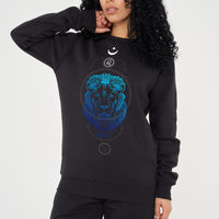 Woman wearing the black LEO Printed Sweatshirt styled with casual bottoms, highlighting the prominent front graphic and cozy fit.