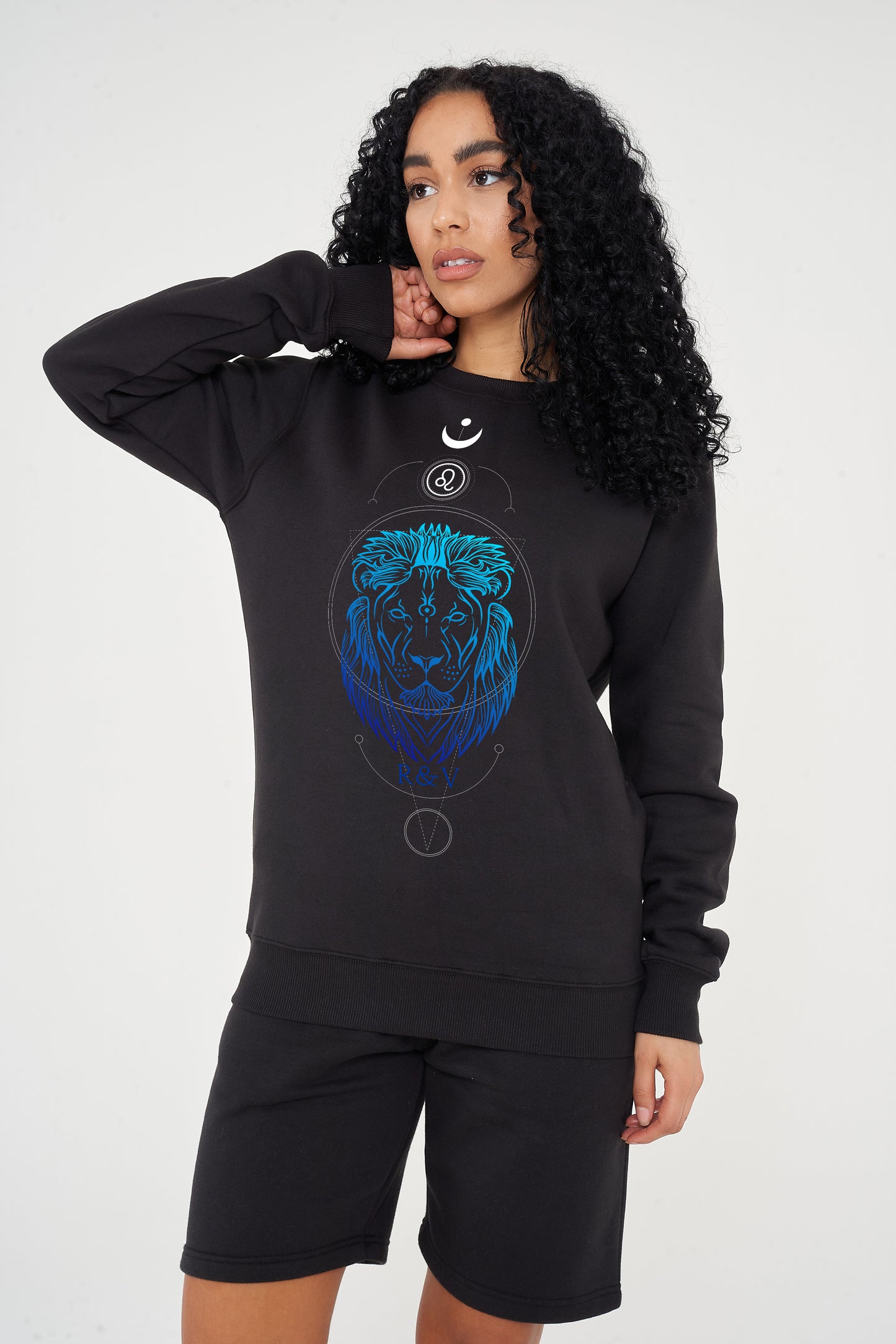 Woman wearing the black LEO Printed Sweatshirt styled with casual bottoms, highlighting the prominent front graphic and cozy fit.