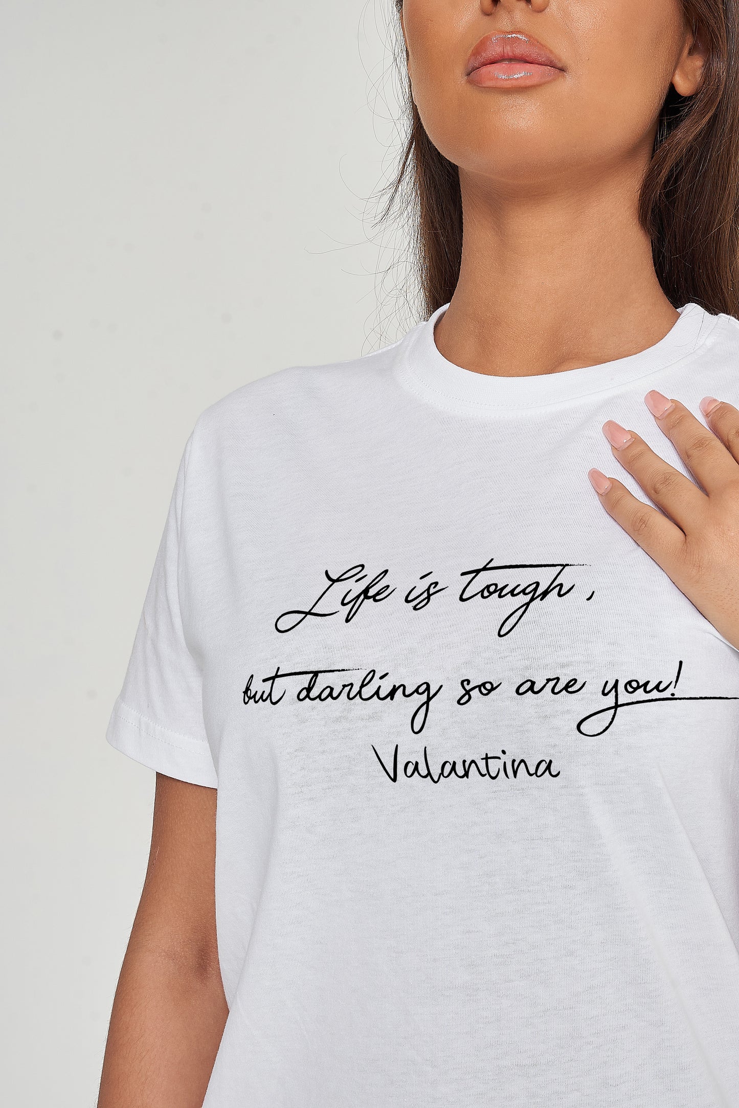 Woman wearing the white Life Is Tough T-Shirt styled with casual bottoms, emphasizing the motivational front print and comfortable fit.