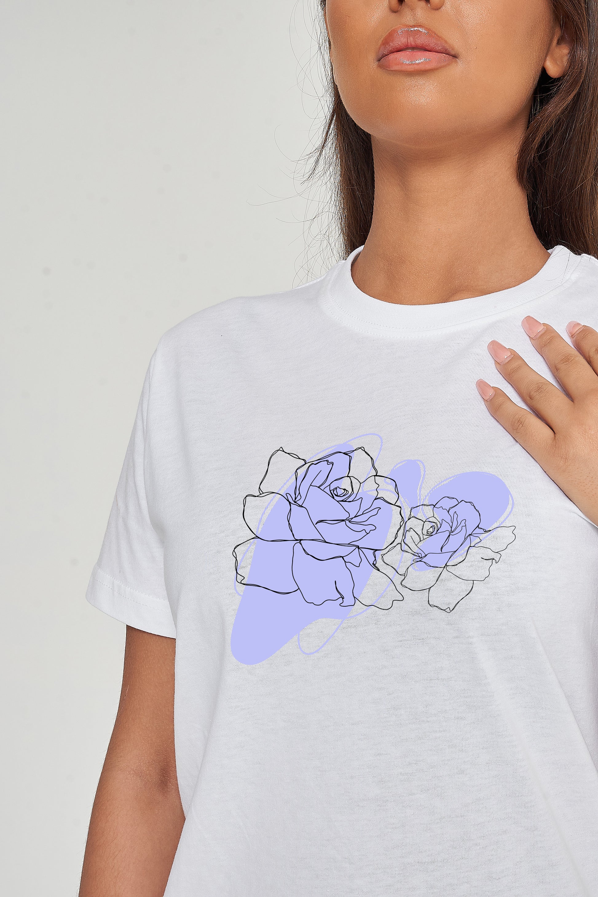 Woman wearing the Lilac Flower Art Oversized T-Shirt styled with casual bottoms, highlighting the gentle front flower print and comfortable oversized fit.