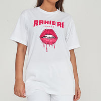 Woman wearing the white Lip Drip Oversized T-Shirt styled with casual bottoms, highlighting the prominent front lip drip graphic and comfortable oversized fit.
